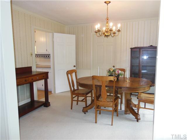 The dining room has plenty of space for sideboards & china cabinets & a good sized table. It flows easily off the kitchen. In background is the 4th bedroom w/ full bath, conveniently separate from the other bedrooms on the other end, nice for guests! Dining Room