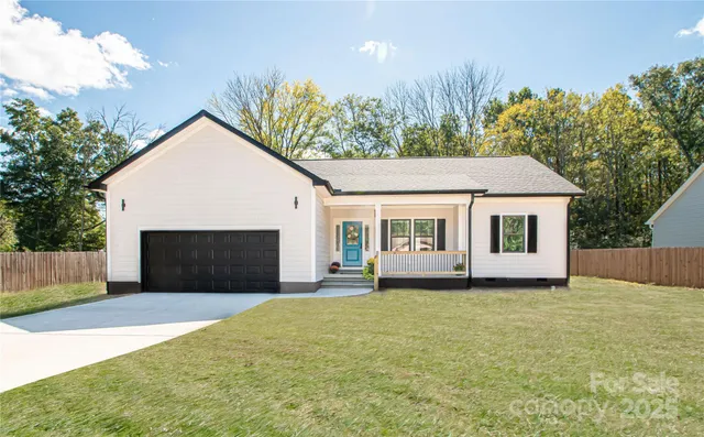 a front view of a house with a garden and yard