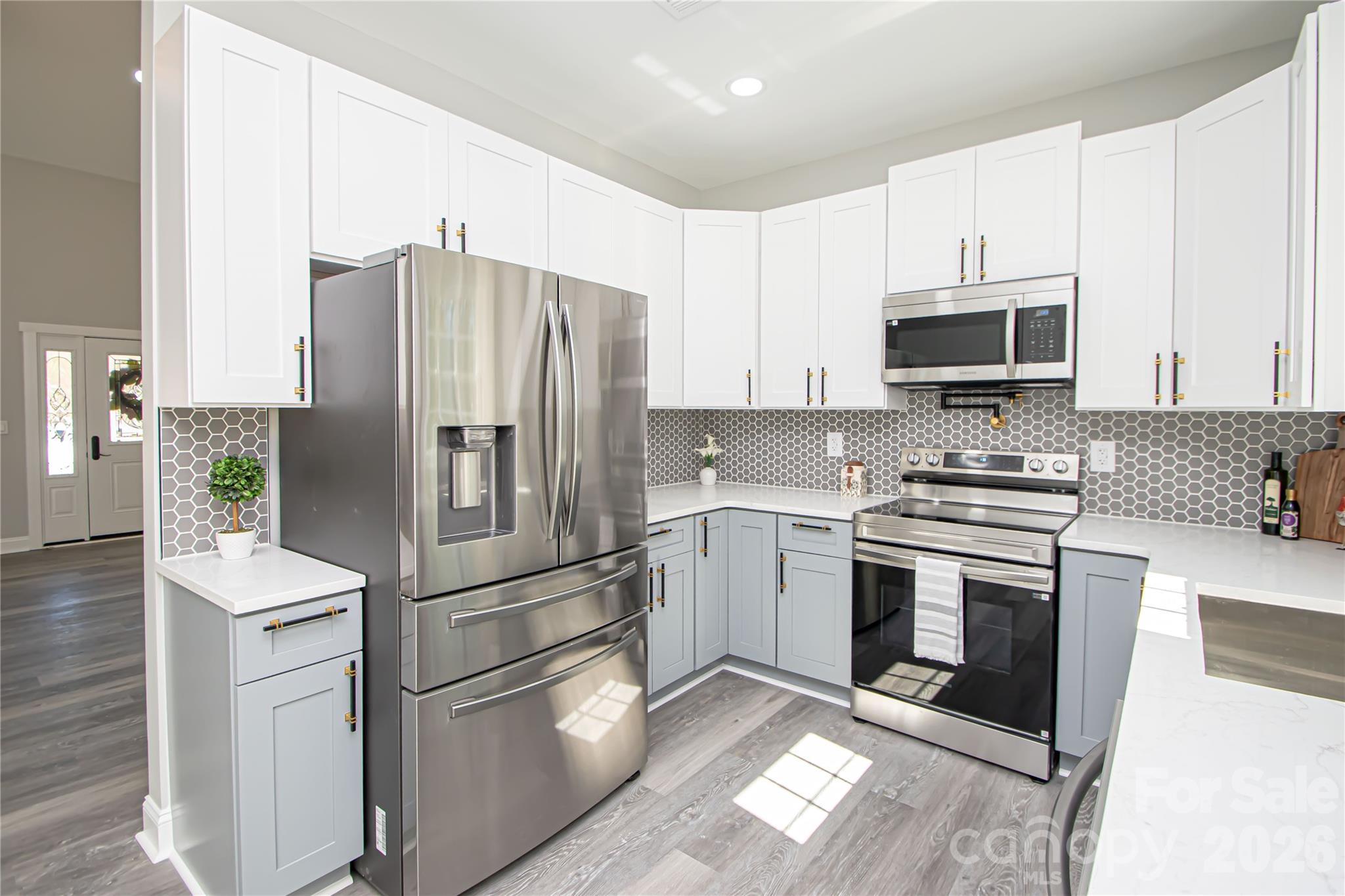 728 Sugar Plum Road Chester, SC 29706 - Photo 12 of 47 a kitchen with stainless steel appliances granite countertop a refrigerator stove a sink and microwave