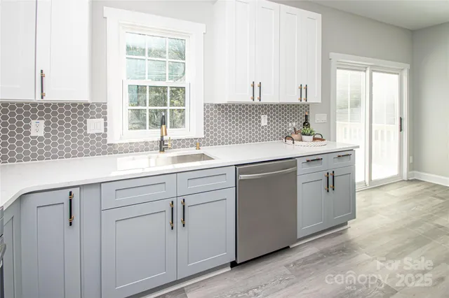 a kitchen with white cabinets and a sink