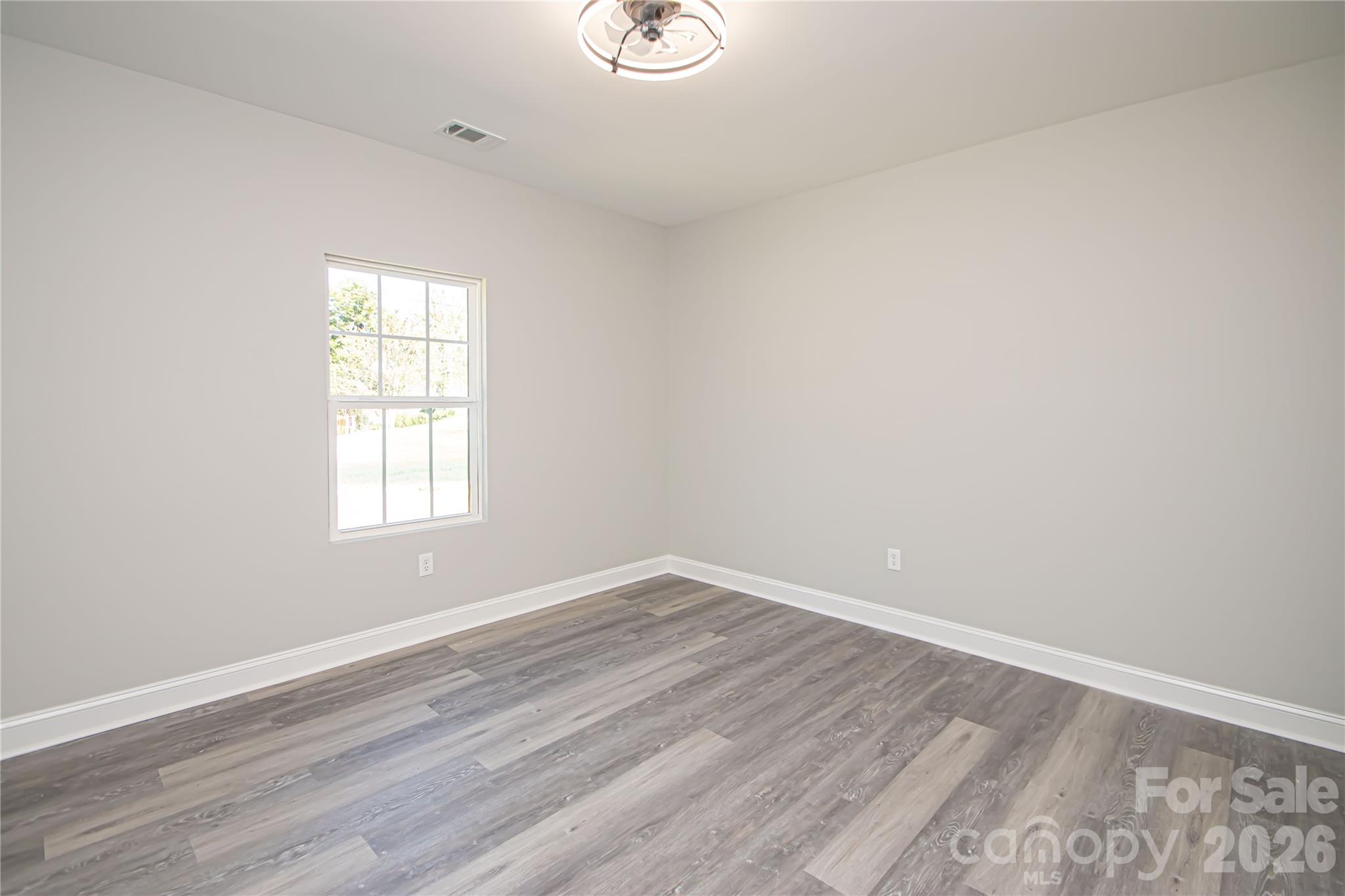728 Sugar Plum Road Chester, SC 29706 - Photo 24 of 47 an empty room with wooden floor and windows