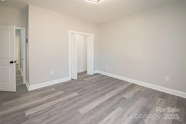 a view of an empty room and wooden floor
