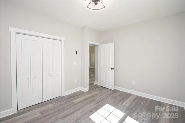 a view of an empty room and wooden floor