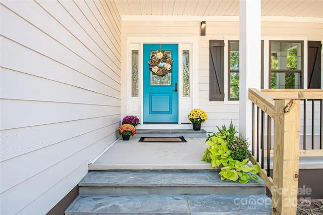 a view of front door of house with potted plant