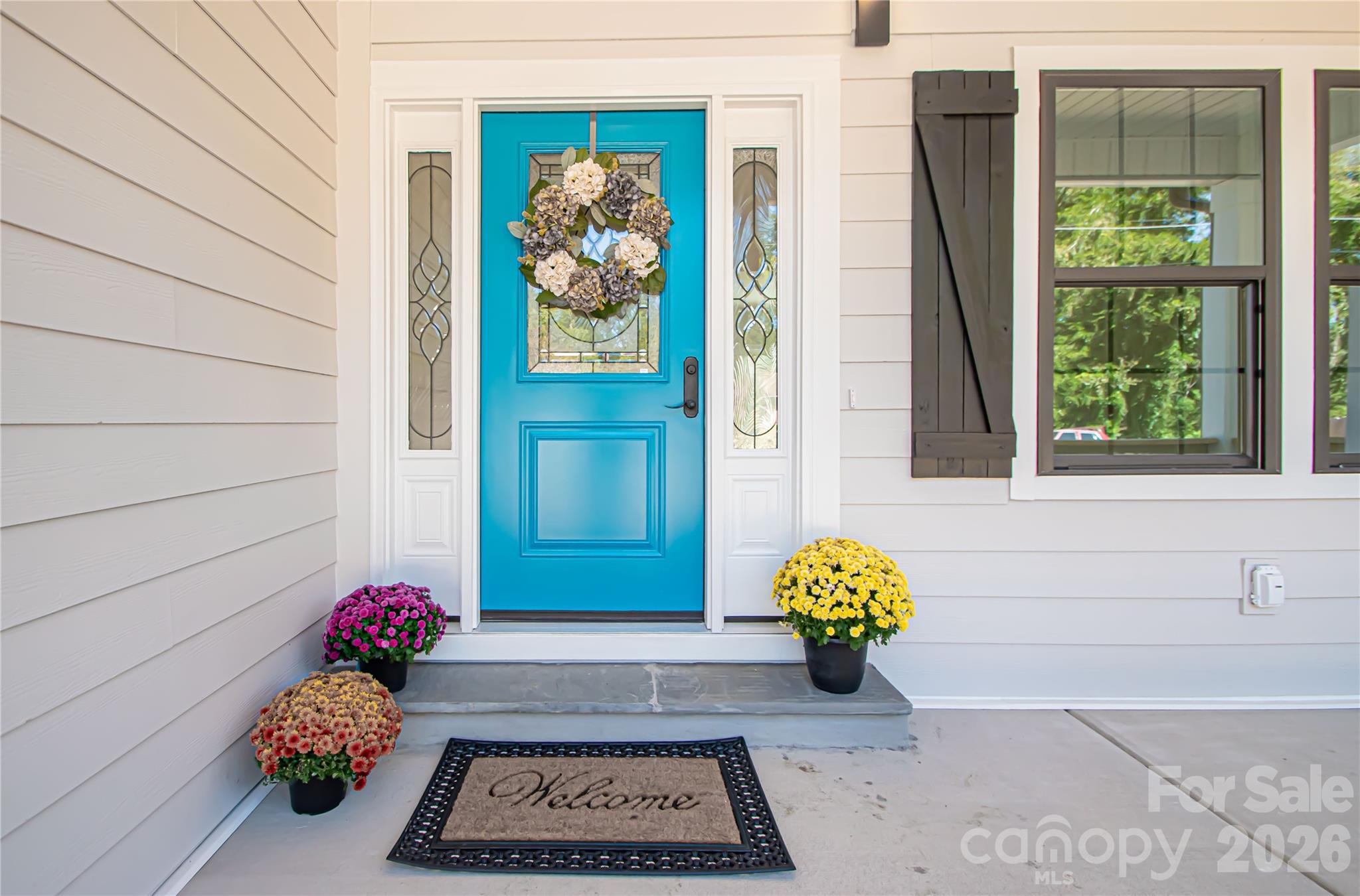 728 Sugar Plum Road Chester, SC 29706 - Photo 4 of 47 a vase of flowers sitting on a floor in front of a door
