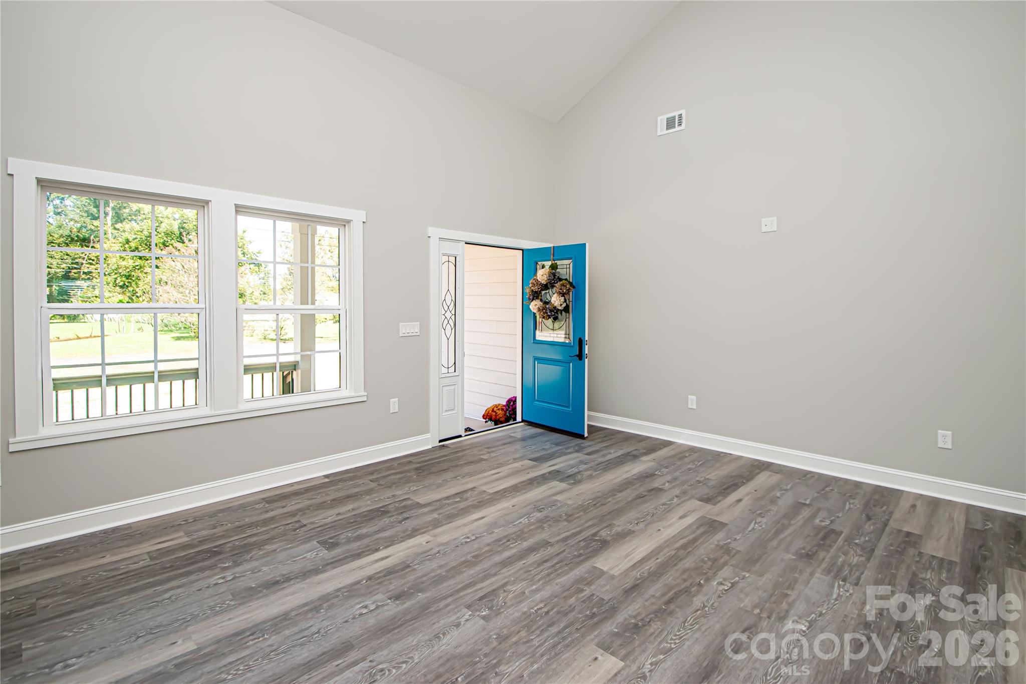 728 Sugar Plum Road Chester, SC 29706 - Photo 5 of 47 a view of an empty room with wooden floor and a window