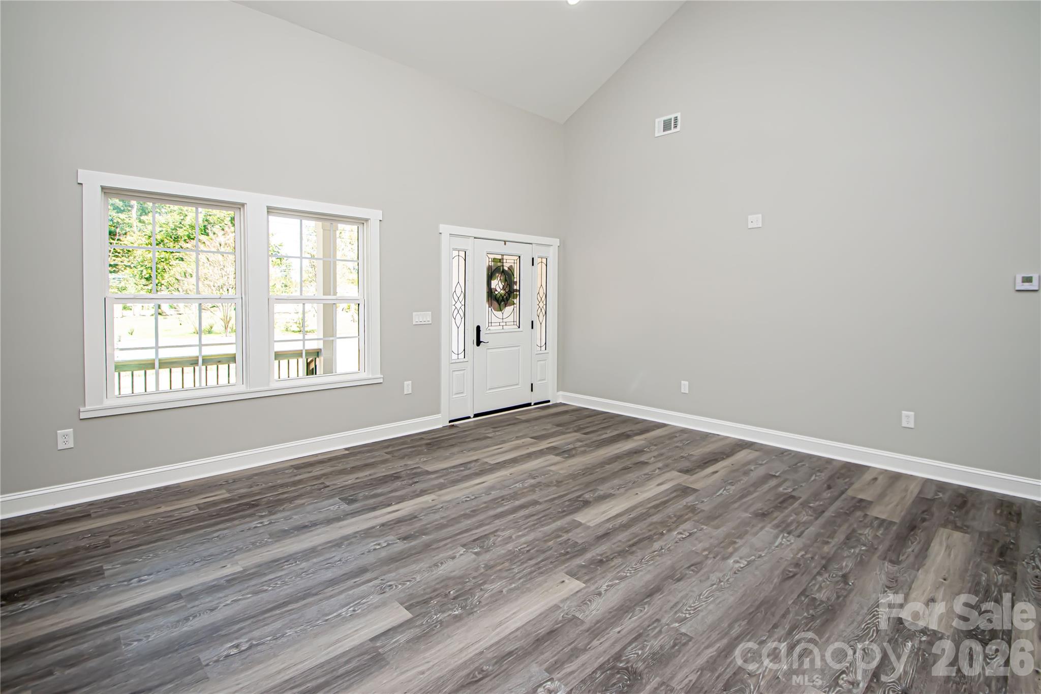 728 Sugar Plum Road Chester, SC 29706 - Photo 7 of 47 an empty room with wooden floor and windows