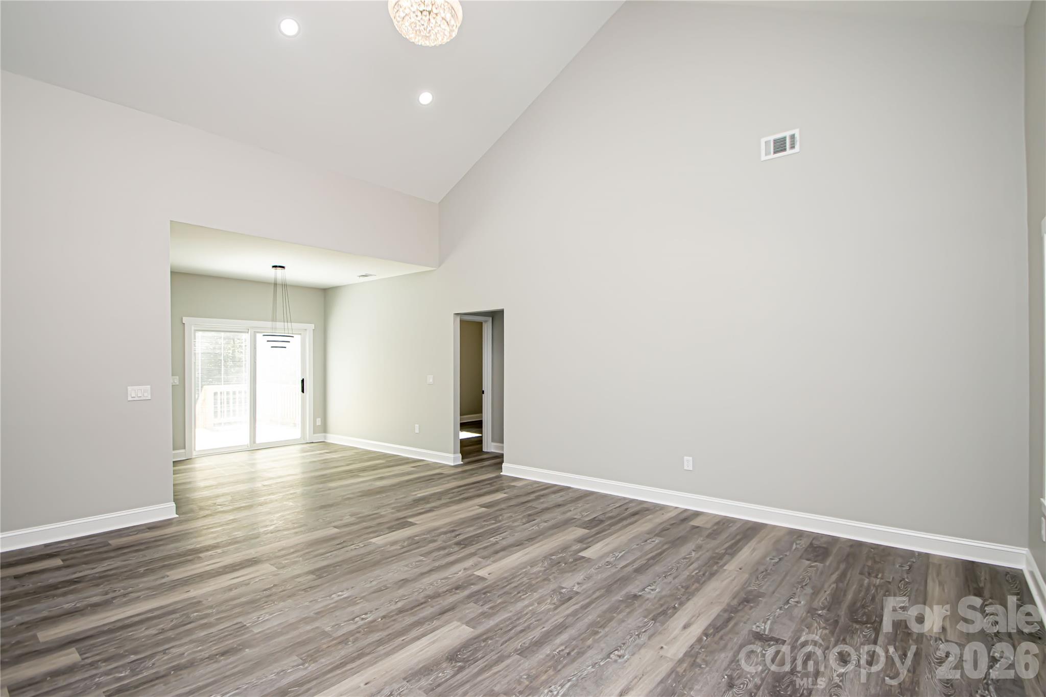728 Sugar Plum Road Chester, SC 29706 - Photo 8 of 47 a view of an empty room with wooden floor and a window