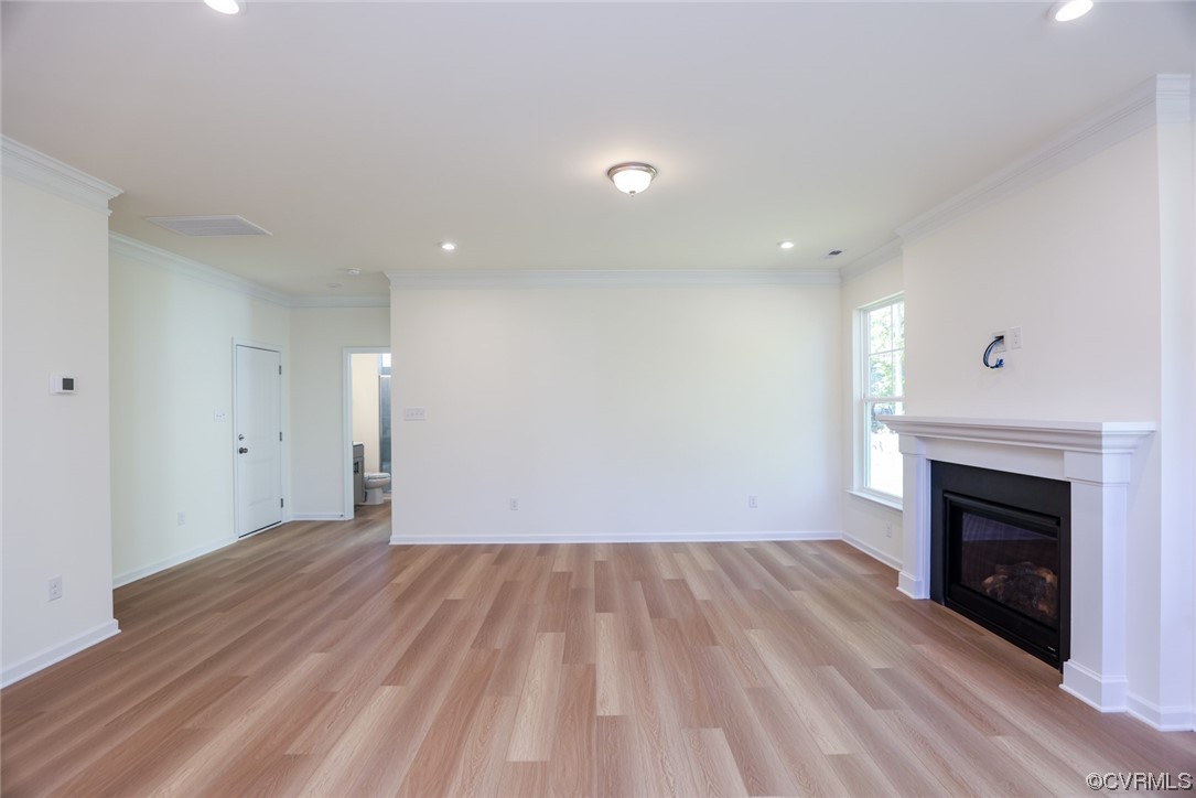 3830 Belspring Road Chester, VA 23831 - Photo 16 of 43 a view of empty room with wooden floor and fireplace