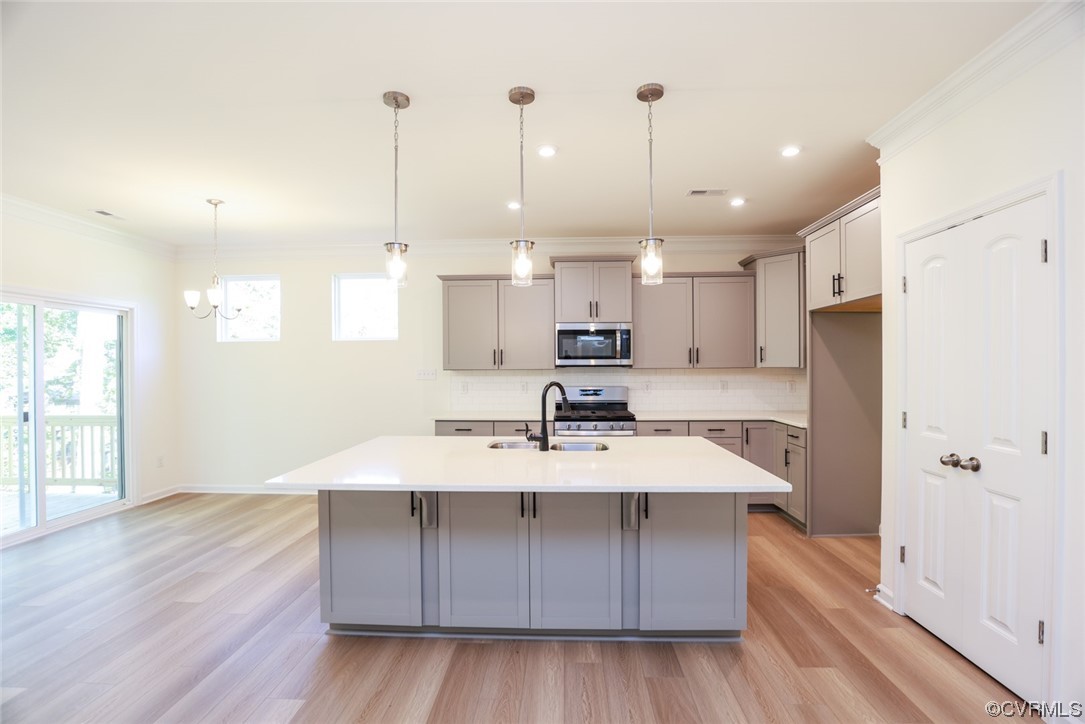 3830 Belspring Road Chester, VA 23831 - Photo 6 of 43 a large kitchen with stainless steel appliances a large counter top a sink a refrigerator and a window