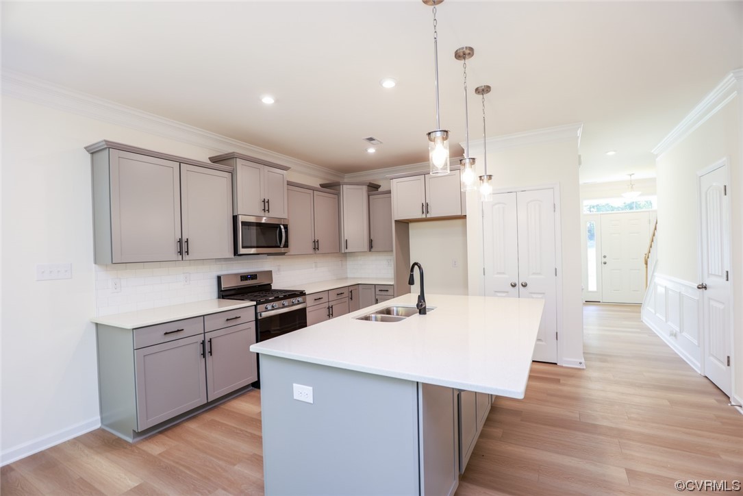 3830 Belspring Road Chester, VA 23831 - Photo 7 of 43 a kitchen with stainless steel appliances kitchen island granite countertop a sink a stove a refrigerator and white cabinets with wooden floor