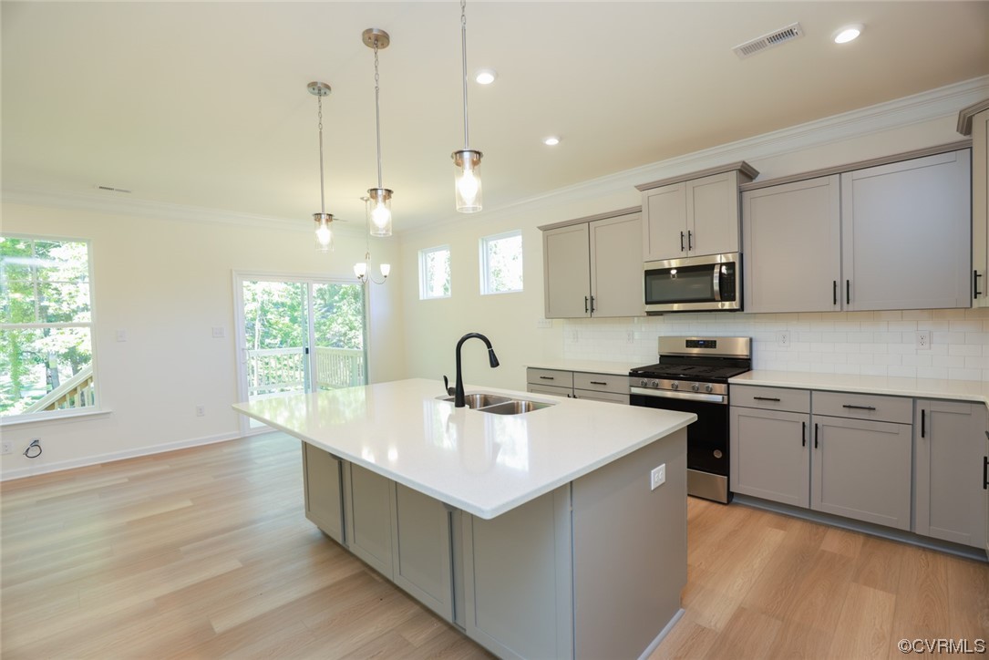 3830 Belspring Road Chester, VA 23831 - Photo 8 of 43 a kitchen with kitchen island a sink a stove and wooden floor