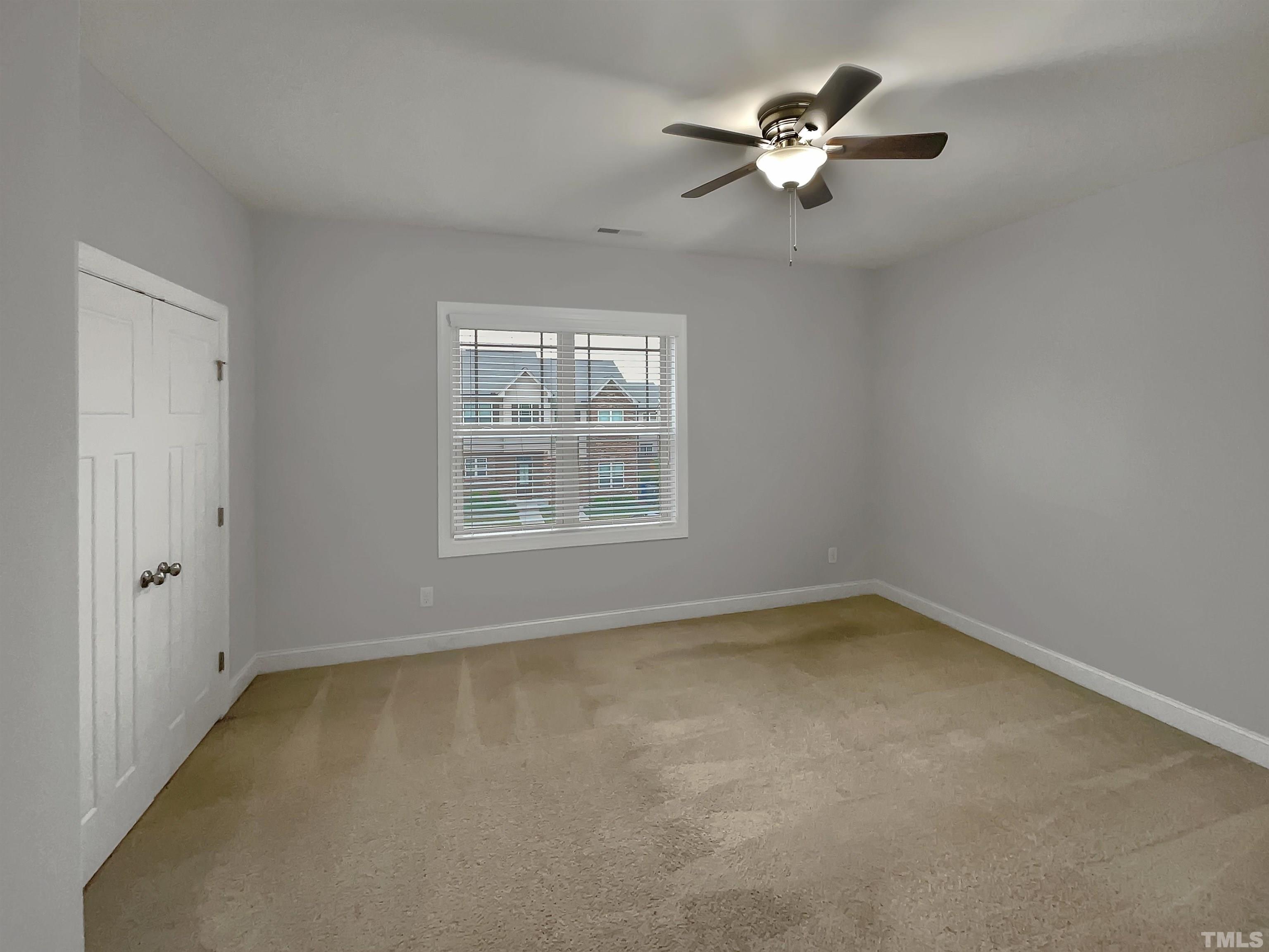 3953 Amelia Park Drive Raleigh, NC 27606 - Photo 11 of 17 an empty room with a window and a ceiling fan