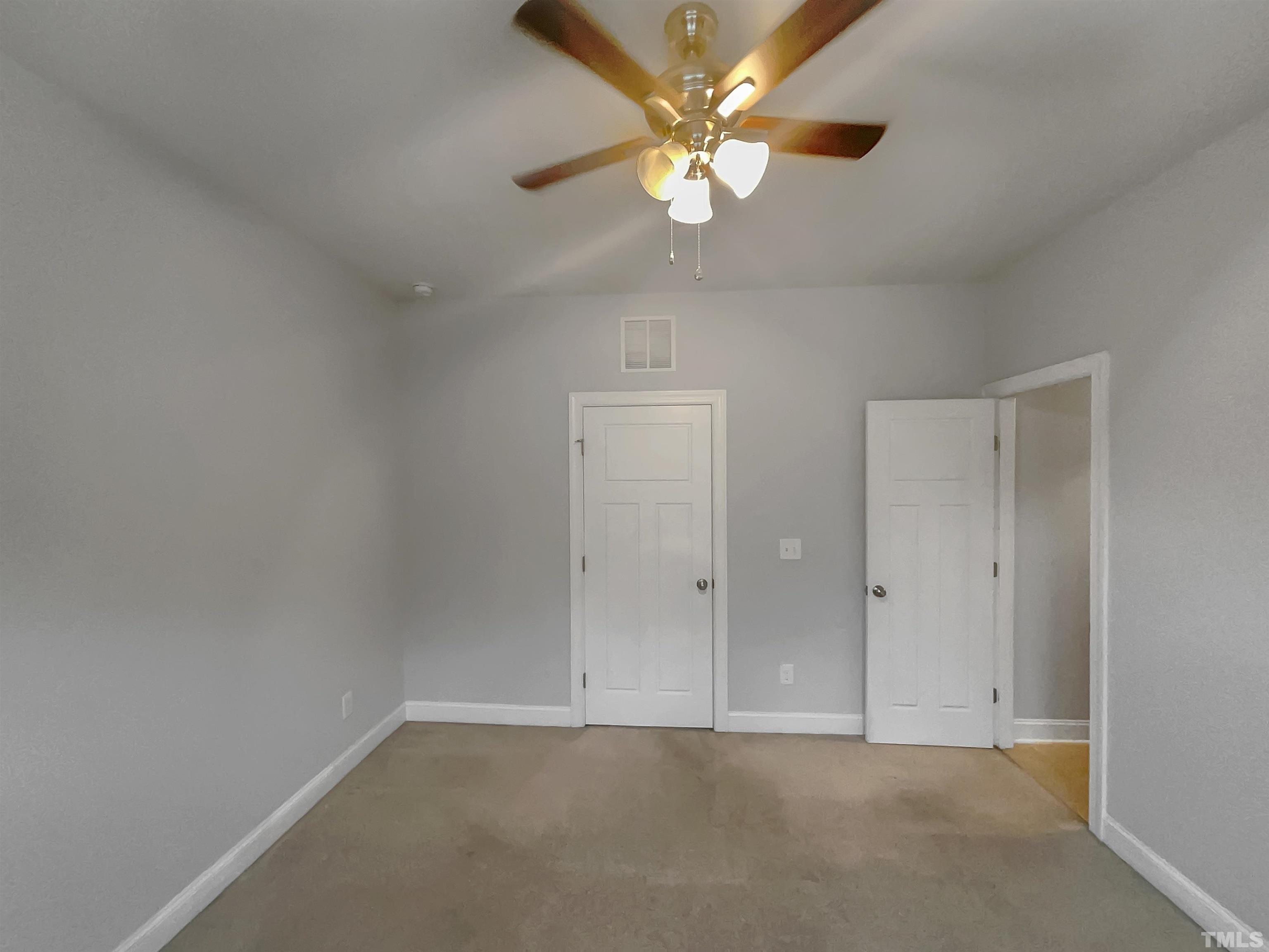 3953 Amelia Park Drive Raleigh, NC 27606 - Photo 15 of 17 an empty room with a chandelier fan