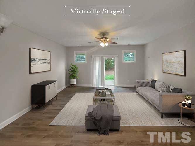3953 Amelia Park Drive Raleigh, NC 27606 - Photo 2 of 17 a living room with furniture and a chandelier