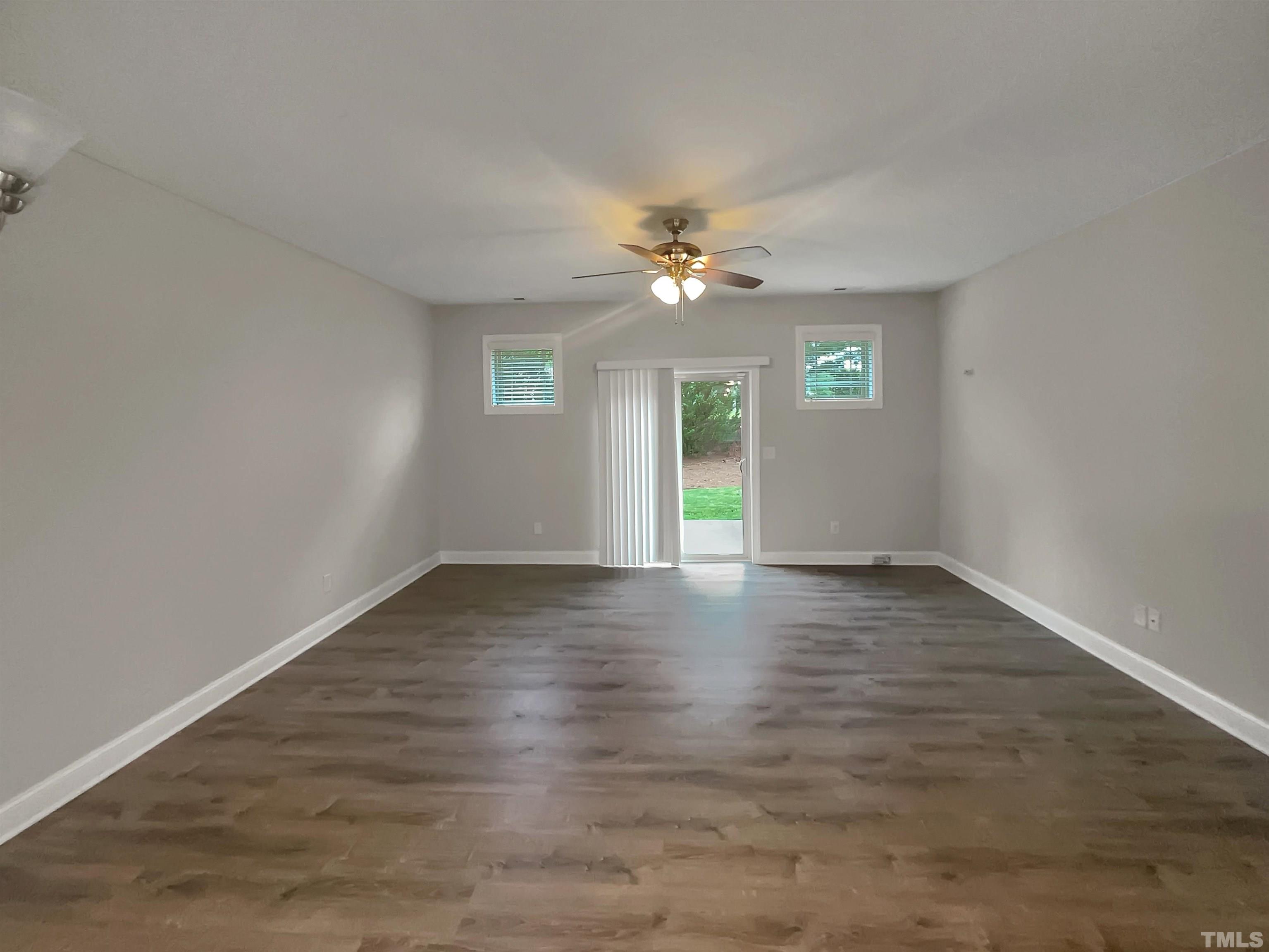 3953 Amelia Park Drive Raleigh, NC 27606 - Photo 5 of 17 wooden floor in an empty room with a window