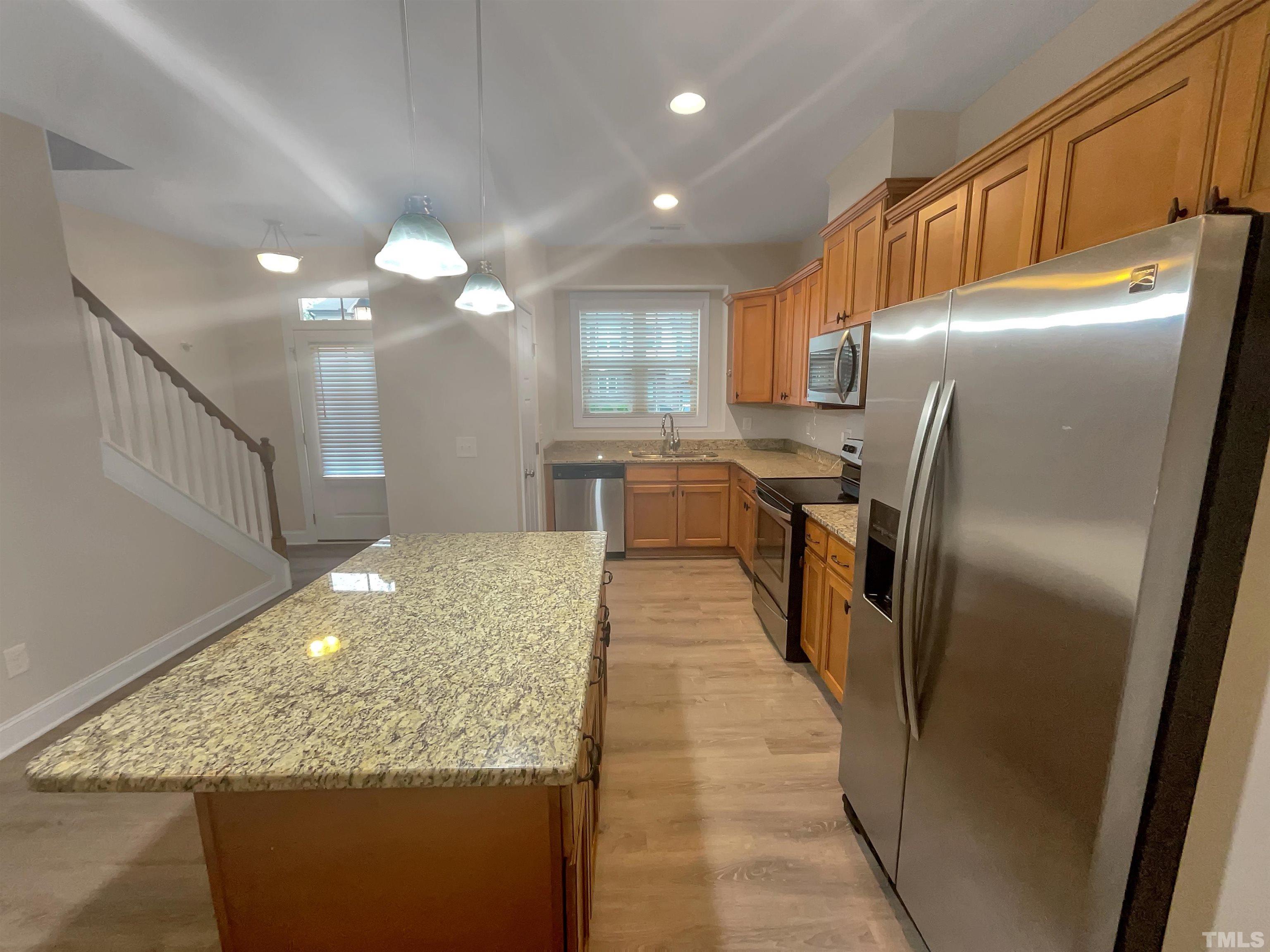 3953 Amelia Park Drive Raleigh, NC 27606 - Photo 9 of 17 a kitchen with stainless steel appliances granite countertop a refrigerator and a sink