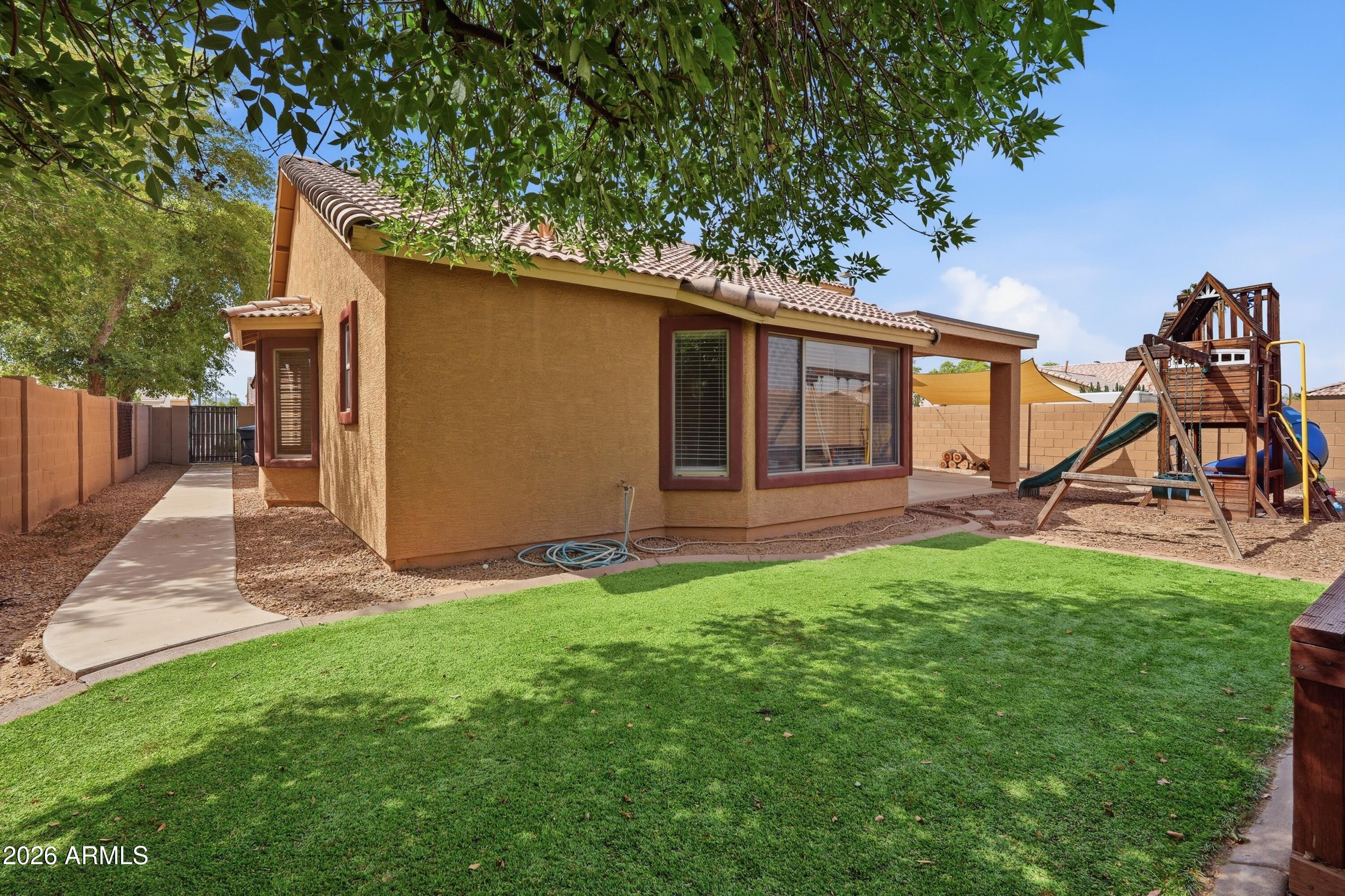 3242 East Bonanza Road Gilbert, AZ 85297 - Photo 32 of 36 a view of an house with backyard and a tree