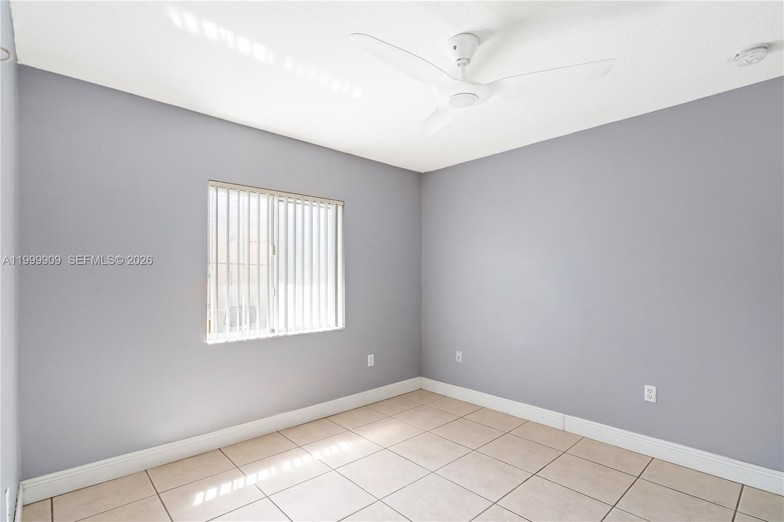 760 Northwest 80th Street, Unit 760 Miami, FL 33150 - Photo 11 of 32 an empty room with windows and fan