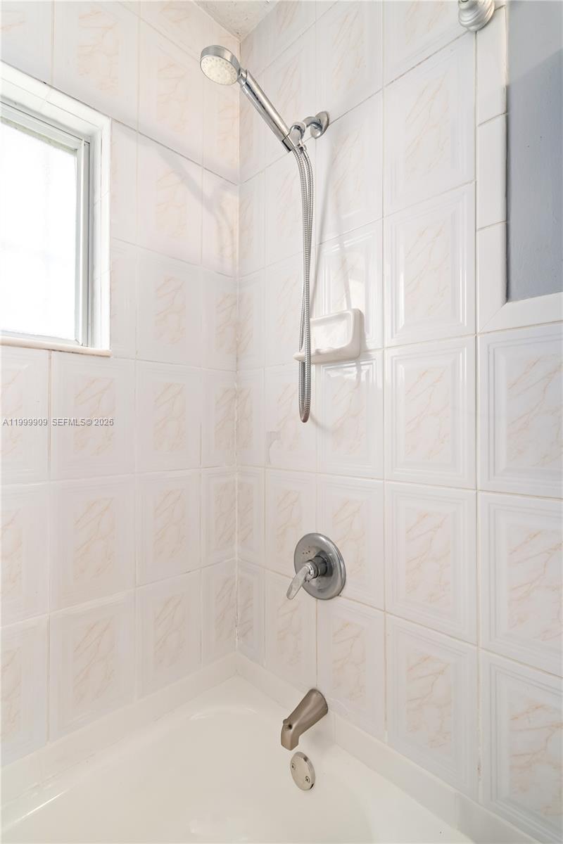 760 Northwest 80th Street, Unit 760 Miami, FL 33150 - Photo 17 of 32 a bathroom with a shower