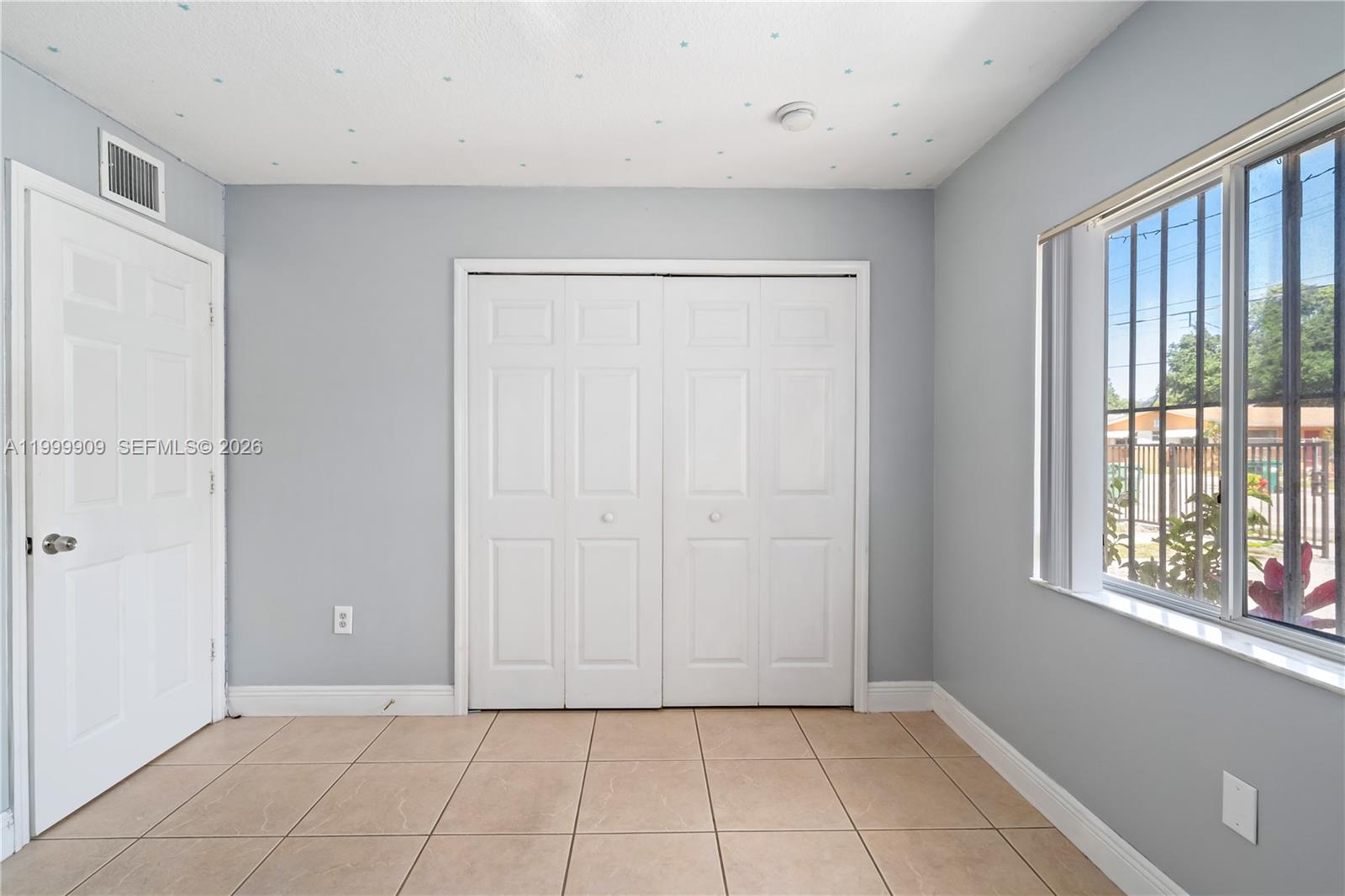 760 Northwest 80th Street, Unit 760 Miami, FL 33150 - Photo 18 of 32 a view of an empty room with a window
