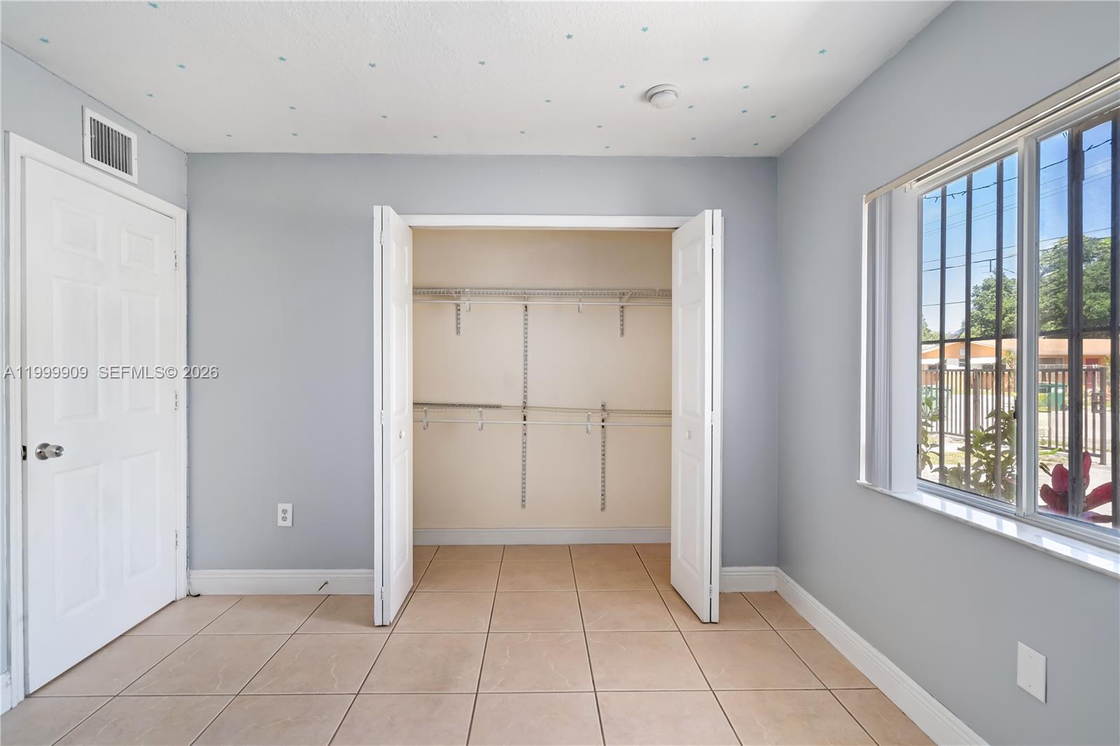 760 Northwest 80th Street, Unit 760 Miami, FL 33150 - Photo 19 of 32 a view of an empty room with window