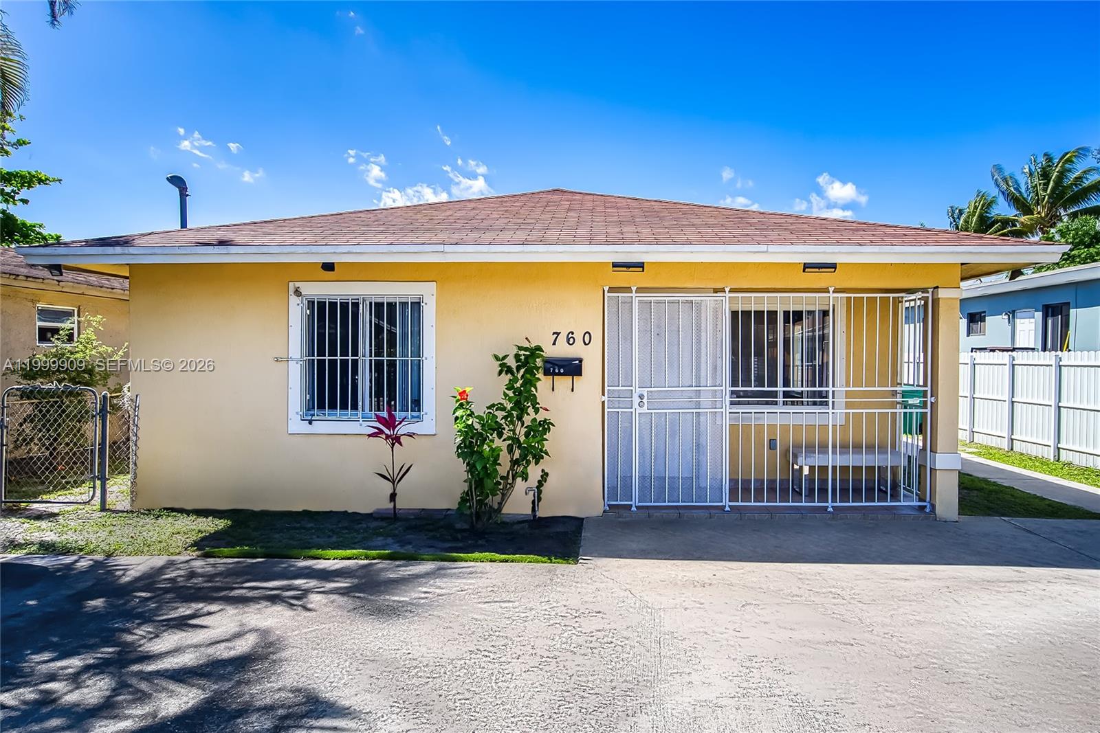 760 Northwest 80th Street, Unit 760 Miami, FL 33150 - Photo 22 of 32 a front view of a house with a yard
