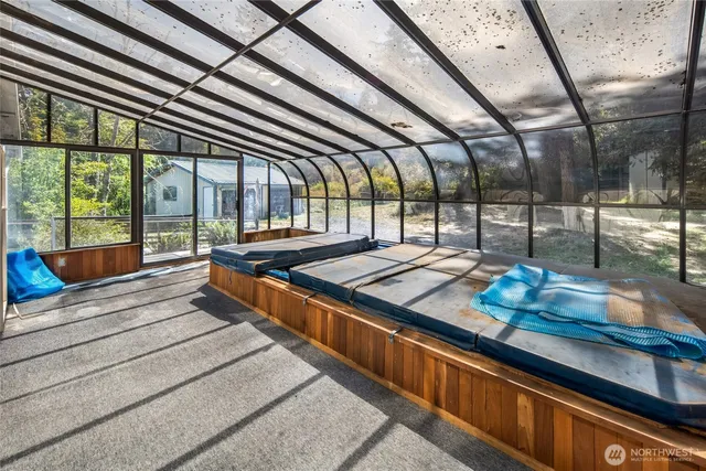 a bed sitting in a room next to a window