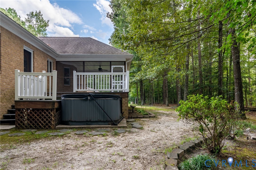 6724 Claiborne Road Sutherland, VA 23885 - Photo 27 of 33 View of yard with a hot tub, a deck, and a sunroom