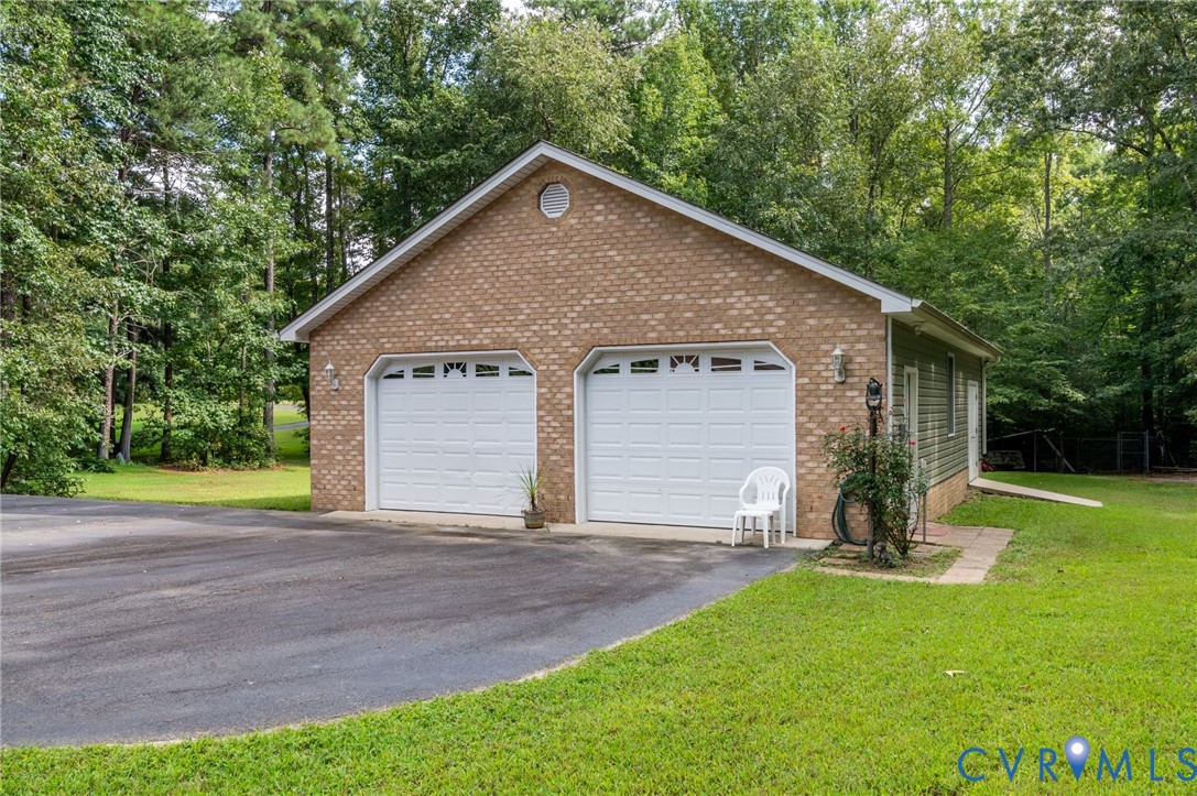 6724 Claiborne Road Sutherland, VA 23885 - Photo 29 of 33 Detached garage featuring view of wooded area