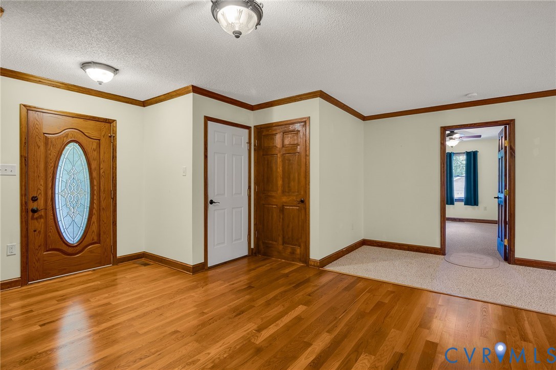 6724 Claiborne Road Sutherland, VA 23885 - Photo 5 of 33 Foyer entrance featuring a textured ceiling, light