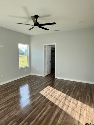 a view of an empty room and wooden floor