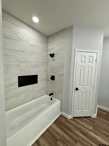 a bathroom with a bathtub and shower