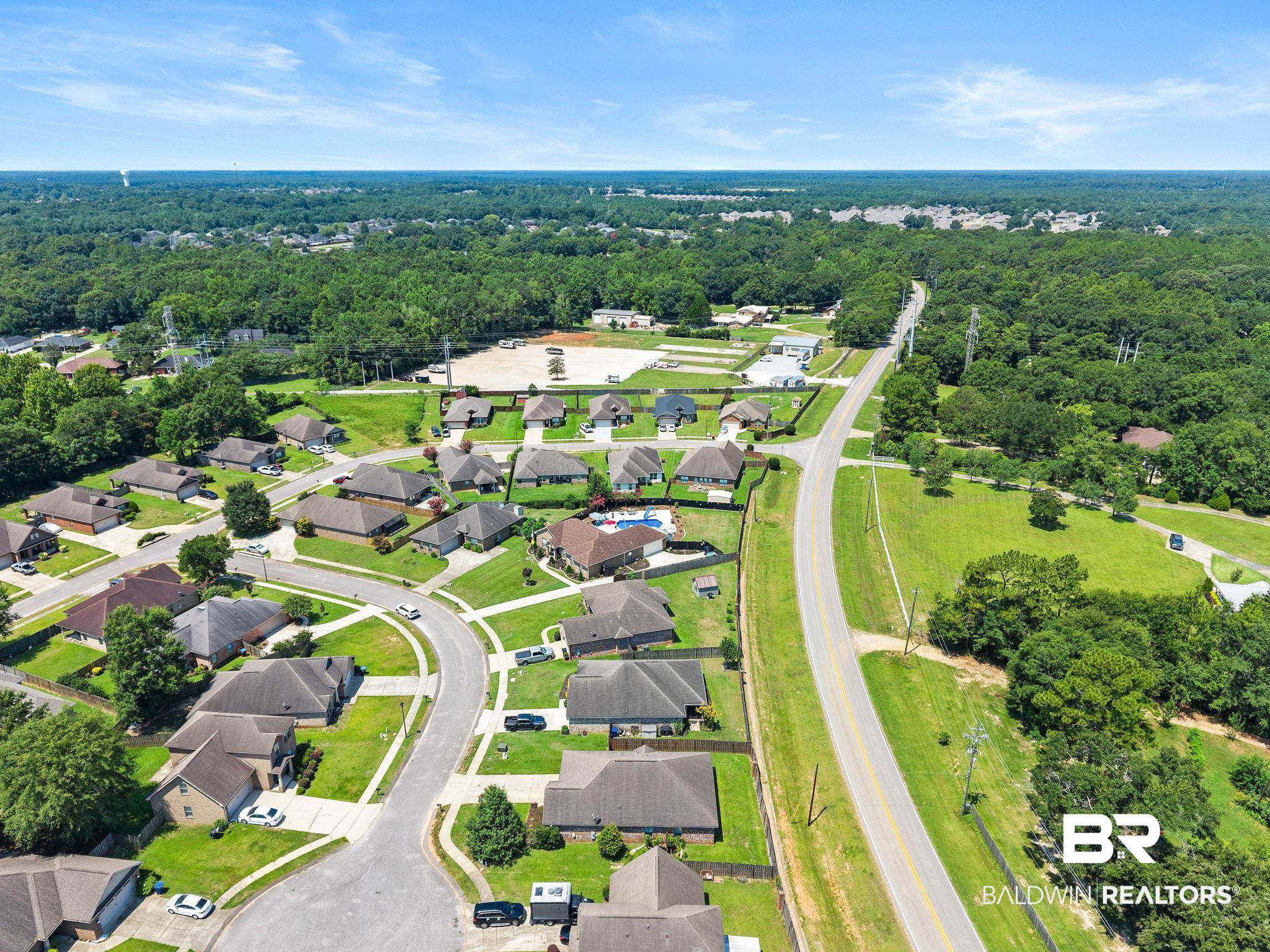 2216 Livingstone Court Mobile, AL 36695 - Photo 58 of 62 Suburban neighborhood featuring established homes with dark shingle roofs, manicured lawns, and mature trees