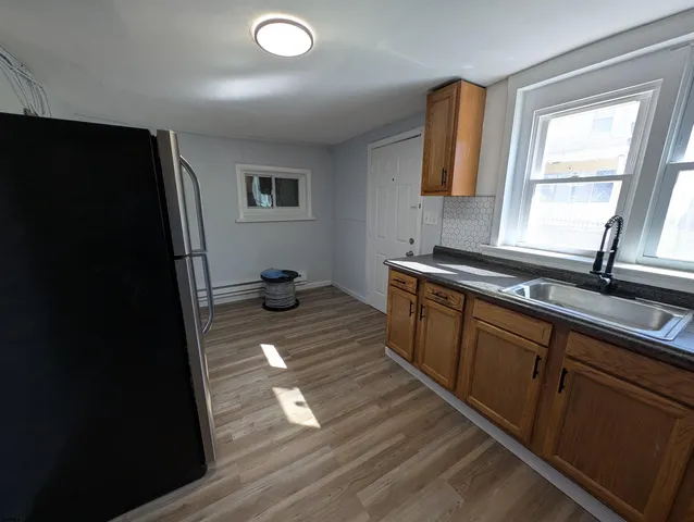 a kitchen with a sink and wooden cabinets