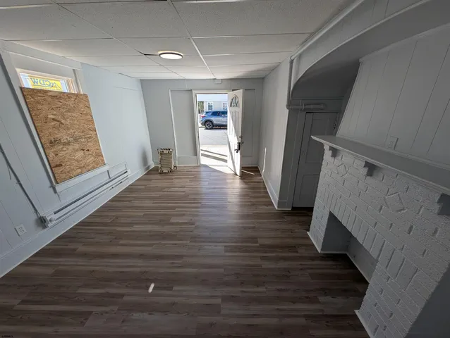 a view of an entryway with wooden floor