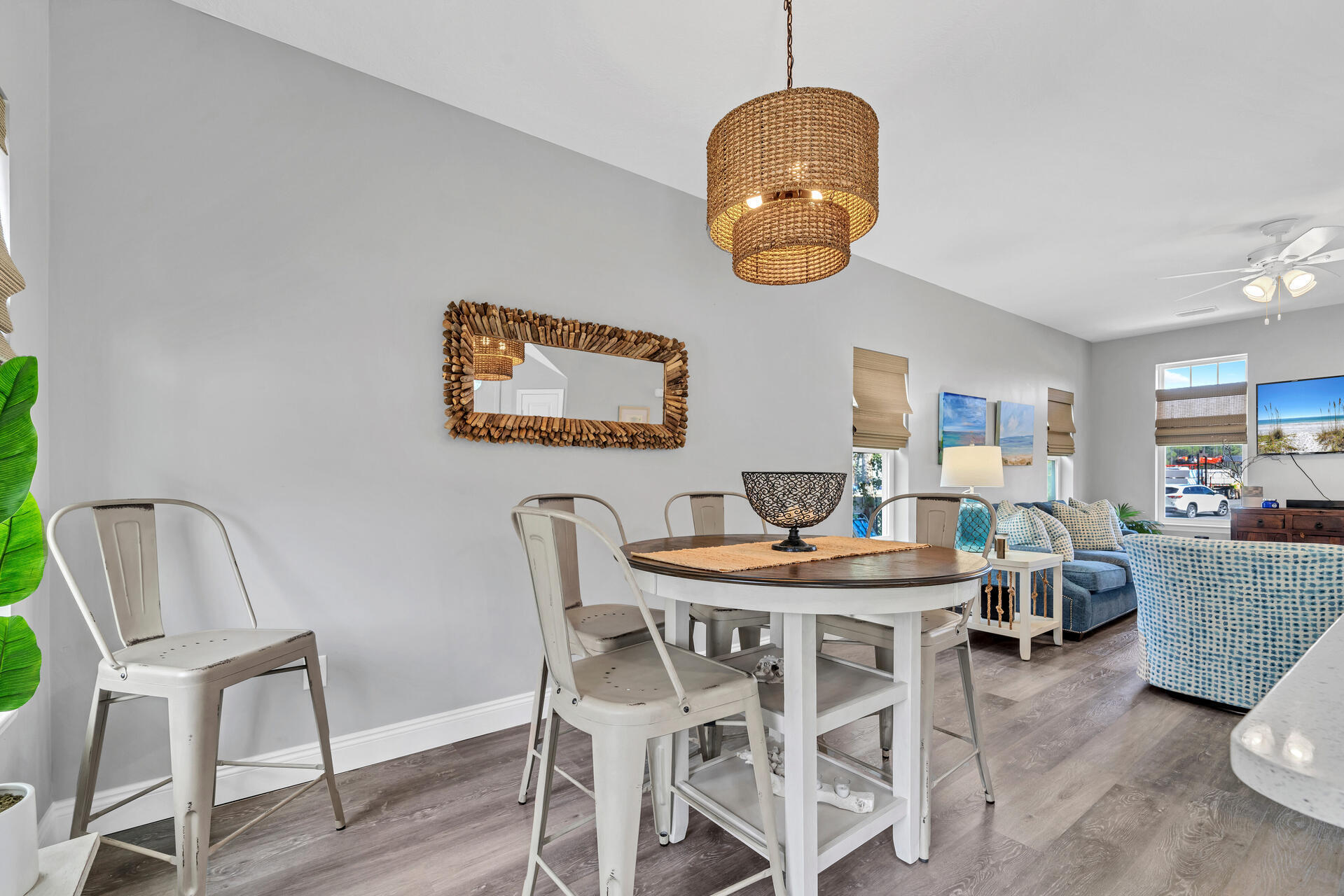 285 Indian Woman Road Santa Rosa Beach, FL 32459 - Photo 12 of 39 a dining room with wooden floor a chandelier a wooden table and chairs