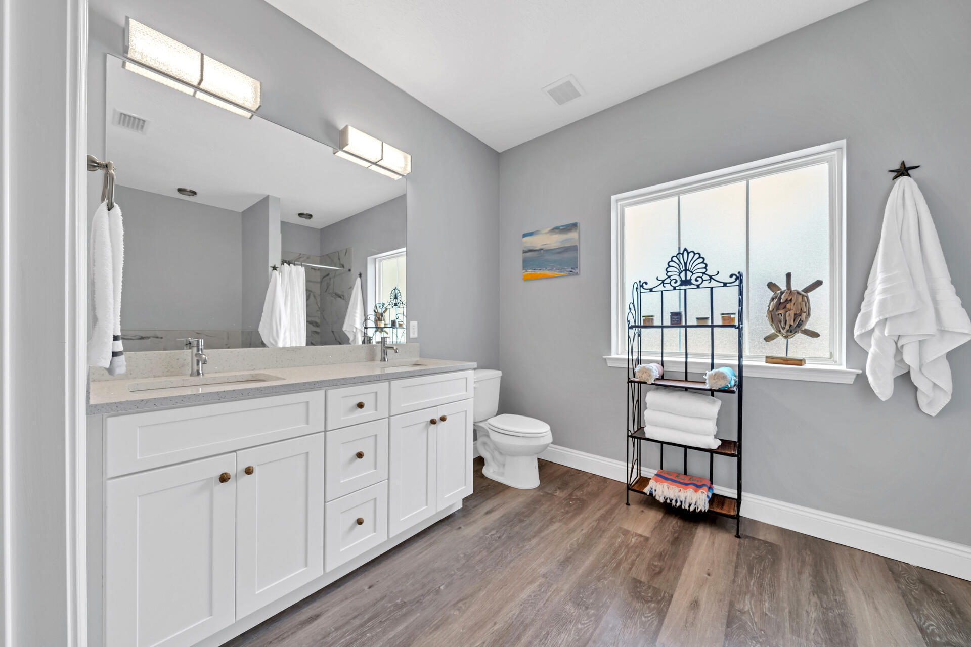 285 Indian Woman Road Santa Rosa Beach, FL 32459 - Photo 18 of 39 a spacious bathroom with a double vanity sink a toilet a shower and a window