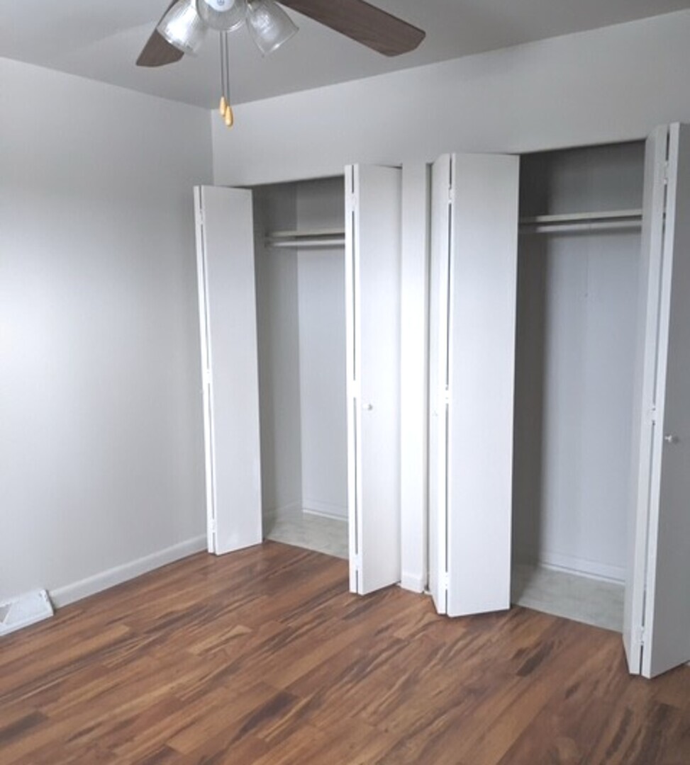 423 Grand Boulevard, Unit 423 Wauconda, IL 60084 - Photo 12 of 14 an empty room with wooden floor fan and window