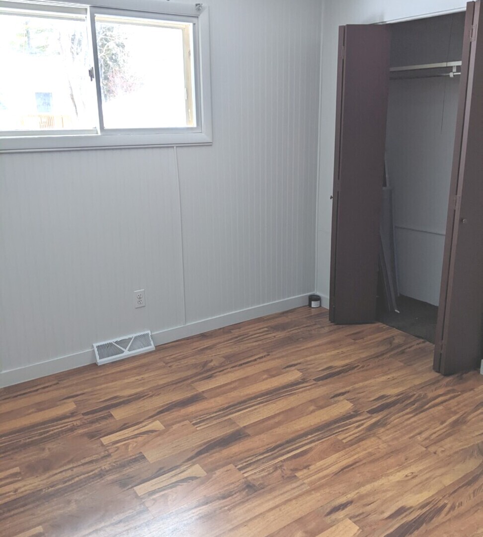 423 Grand Boulevard, Unit 423 Wauconda, IL 60084 - Photo 13 of 14 an empty room with wooden floor and windows
