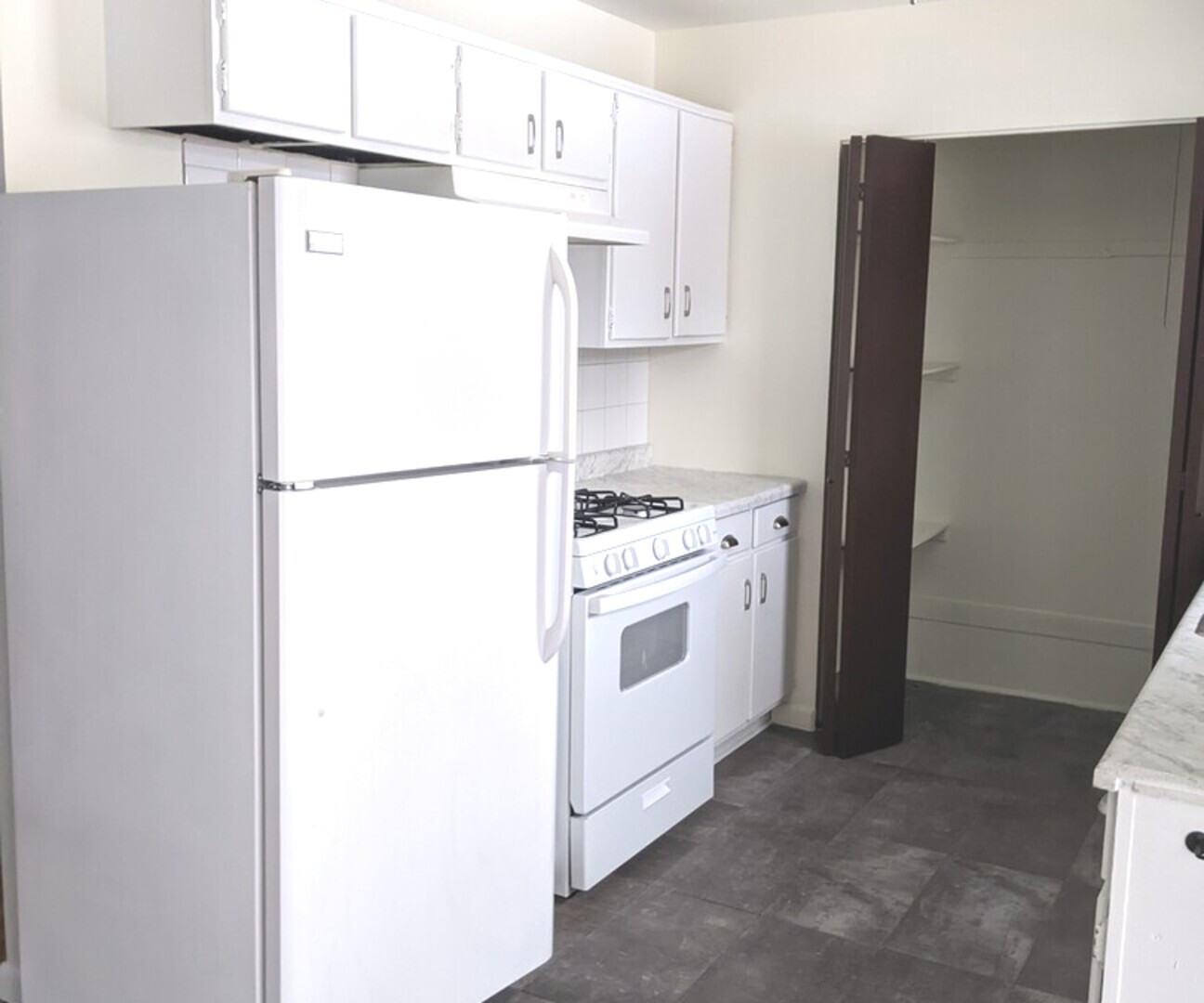 423 Grand Boulevard, Unit 423 Wauconda, IL 60084 - Photo 3 of 14 a white refrigerator freezer and a stove sitting inside of a kitchen