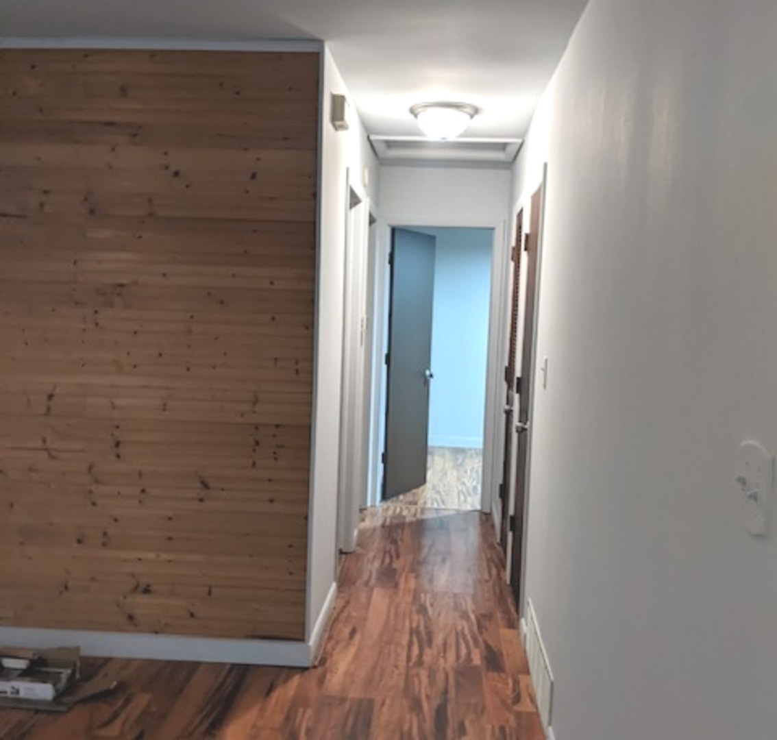 423 Grand Boulevard, Unit 423 Wauconda, IL 60084 - Photo 4 of 14 a view of a hallway with wooden floor