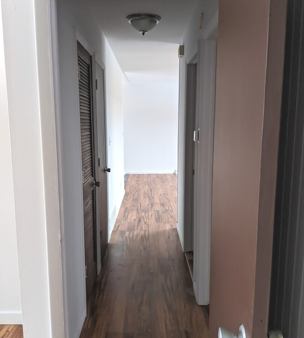 423 Grand Boulevard, Unit 423 Wauconda, IL 60084 - Photo 5 of 14 a view of a hallway with wooden floor