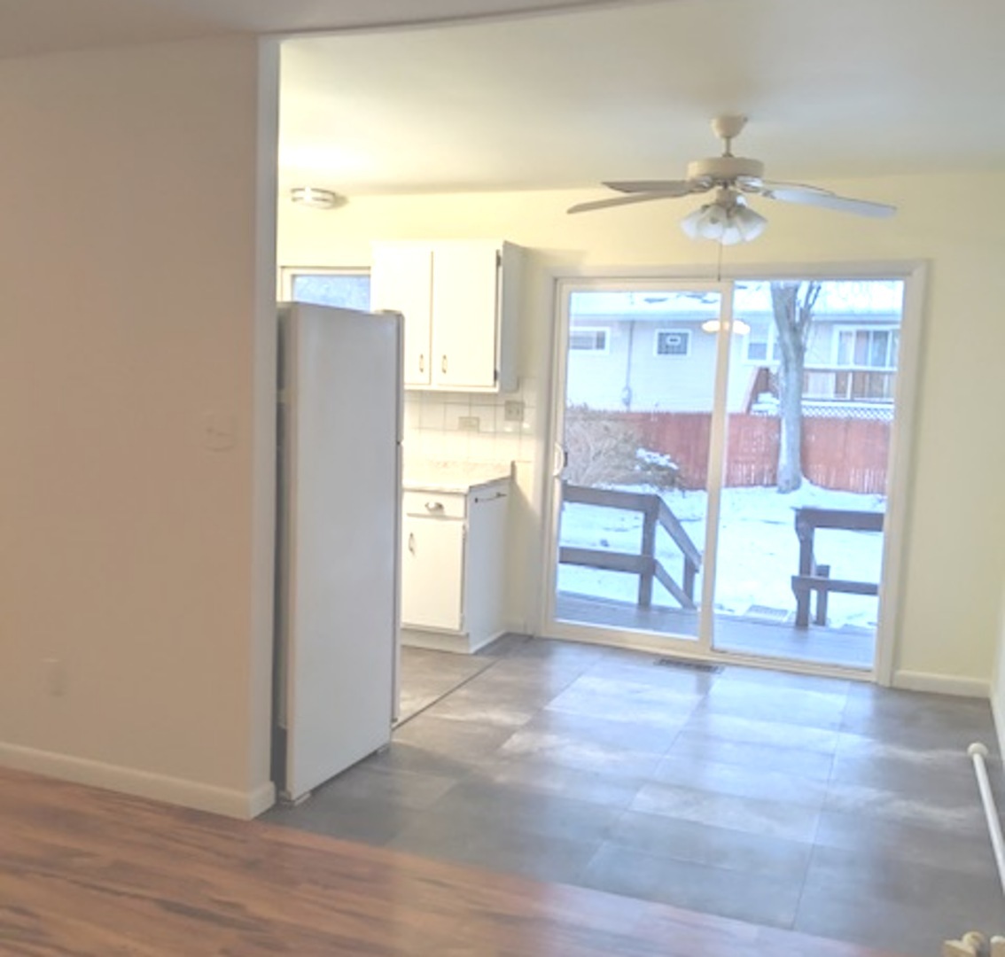 423 Grand Boulevard, Unit 423 Wauconda, IL 60084 - Photo 7 of 14 a view of an empty room with a window
