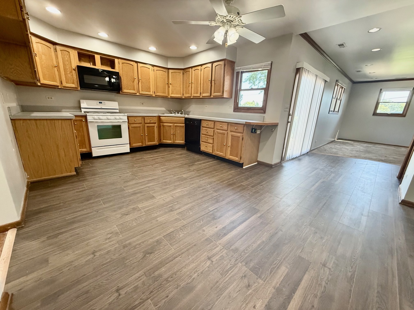 707 Sunset Circle Streamwood, IL 60107 - Photo 11 of 17 a kitchen with stainless steel appliances granite countertop a stove top oven a sink dishwasher and a microwave oven on the wooden floor
