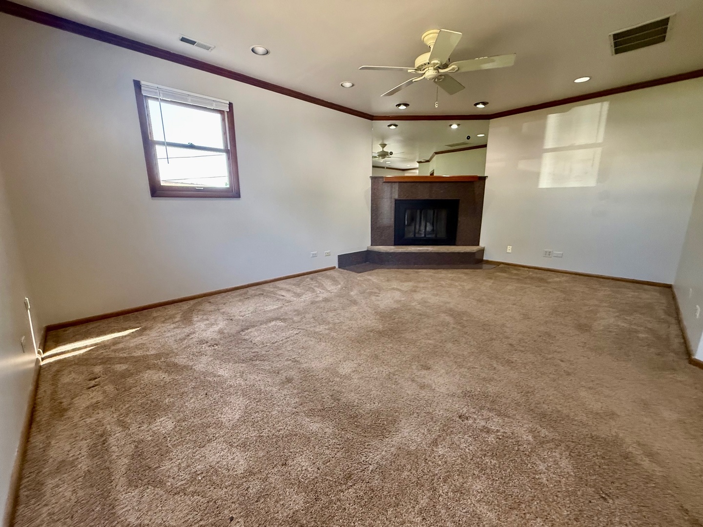707 Sunset Circle Streamwood, IL 60107 - Photo 12 of 17 an empty room with a fireplace and chandelier fan