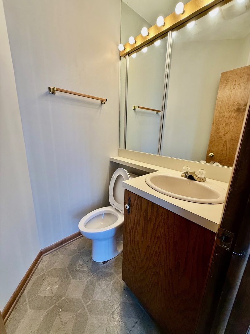 707 Sunset Circle Streamwood, IL 60107 - Photo 13 of 17 a bathroom with a sink a toilet and a mirror