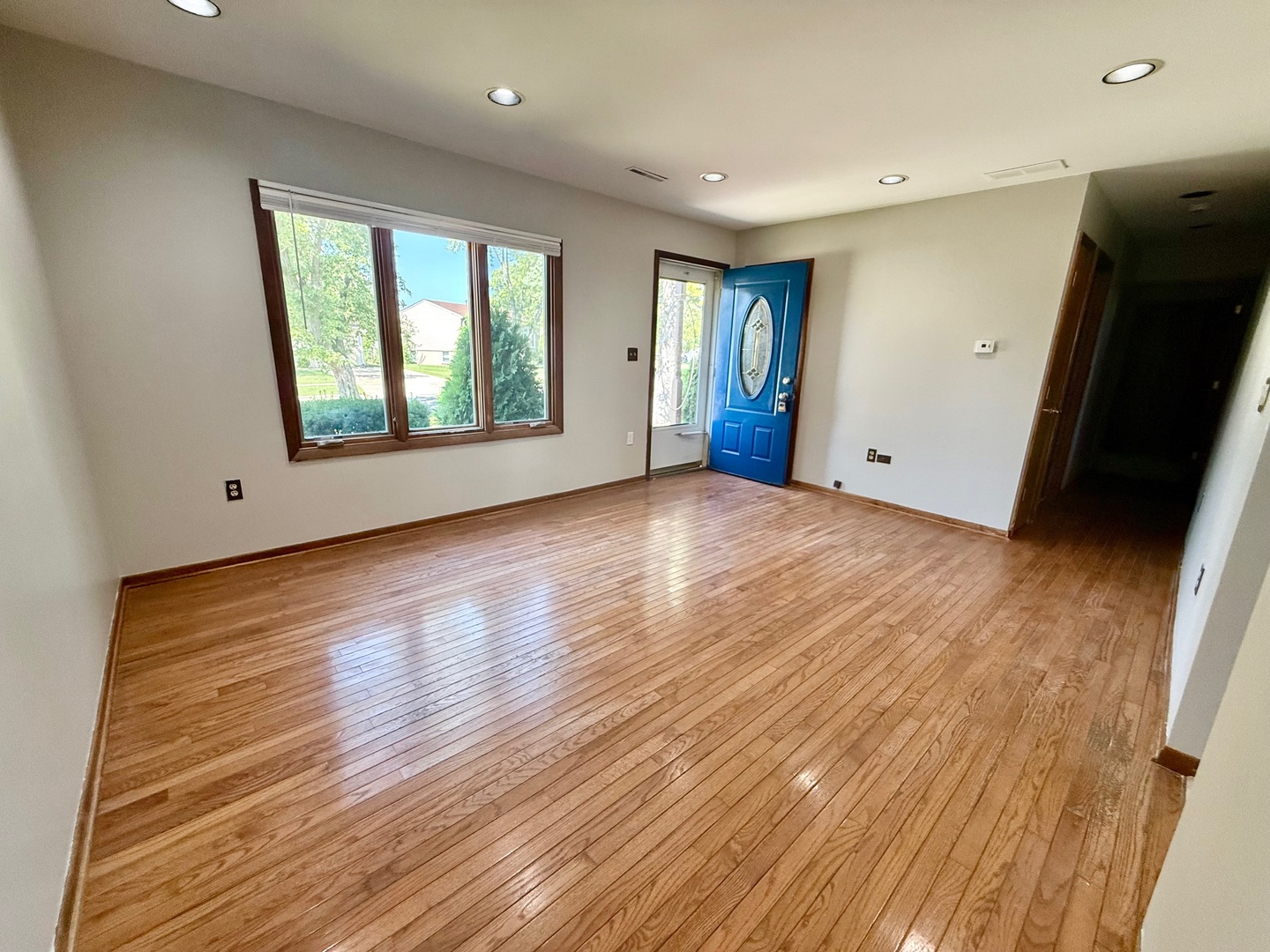 707 Sunset Circle Streamwood, IL 60107 - Photo 3 of 17 a view of an empty room with window and wooden floor