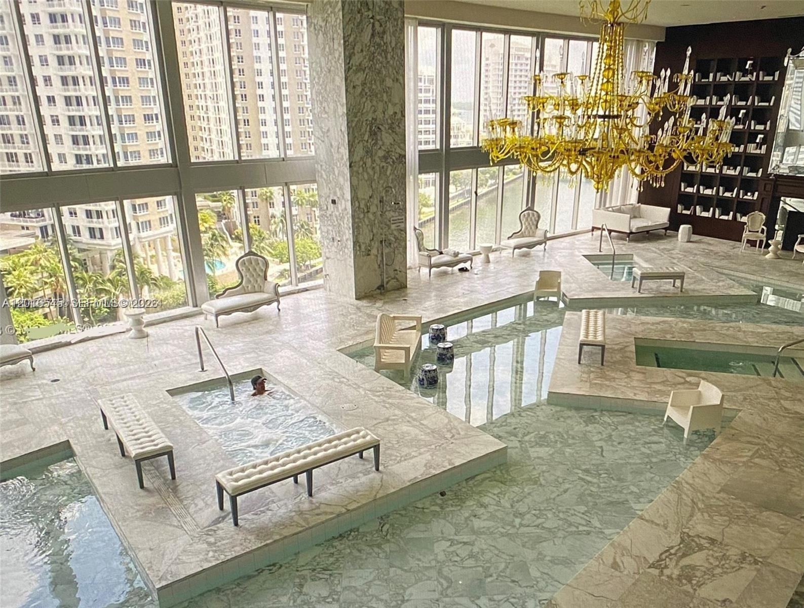 475 Brickell Avenue, Unit 3508 Miami, FL 33131 - Photo 5 of 7 a living room with furniture a large window and floor to ceiling window
