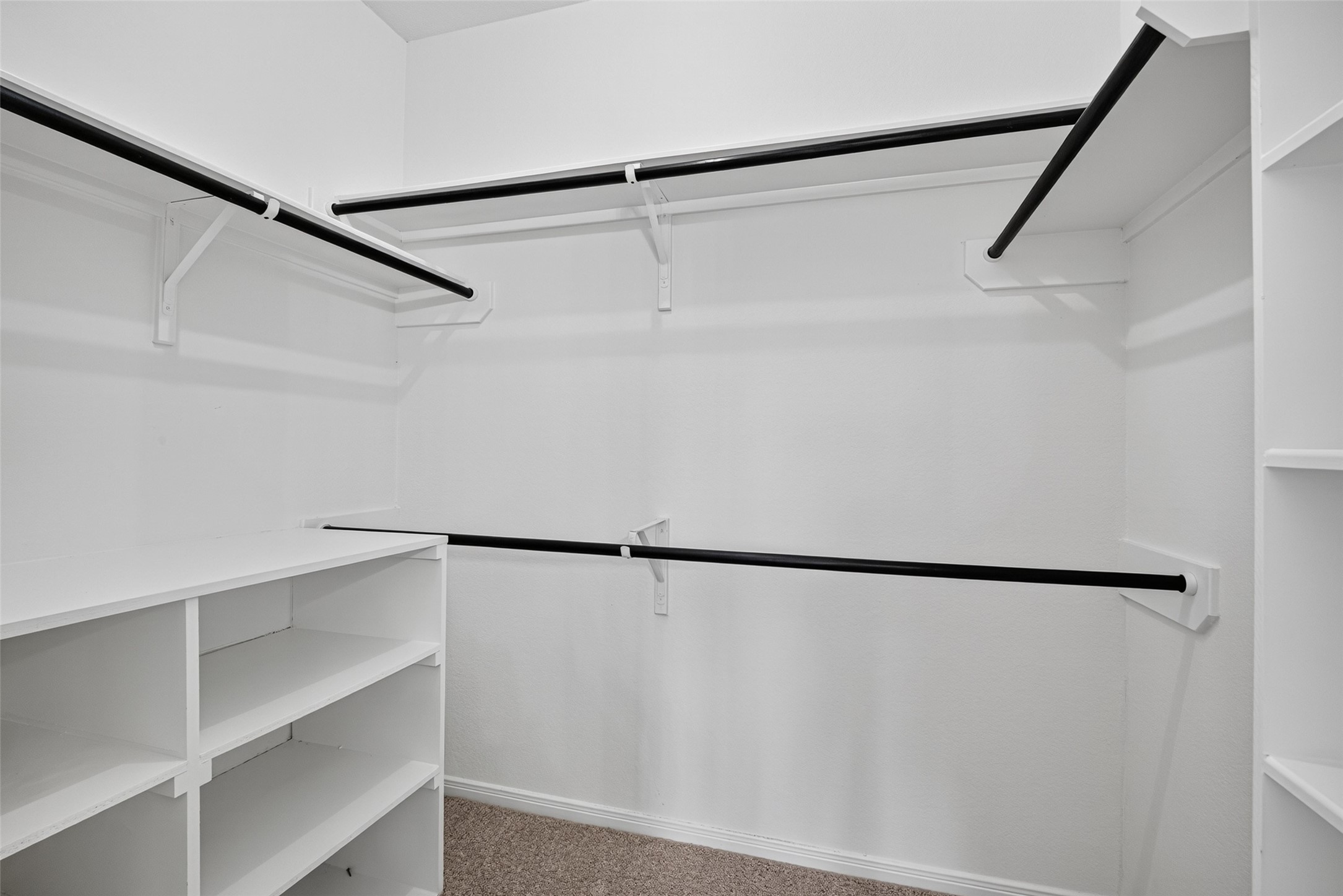22623 Ebbets Field Drive Spring, TX 77389 - Photo 24 of 43 Step inside a spacious walk-in closet designed to make getting ready a breeze. With generous hanging space and custom built-in shelving, keeping your wardrobe neatly organized and instantly accessible feels completely effortless.